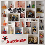 A display case of Aardman characters, portrait paintings and photographs.